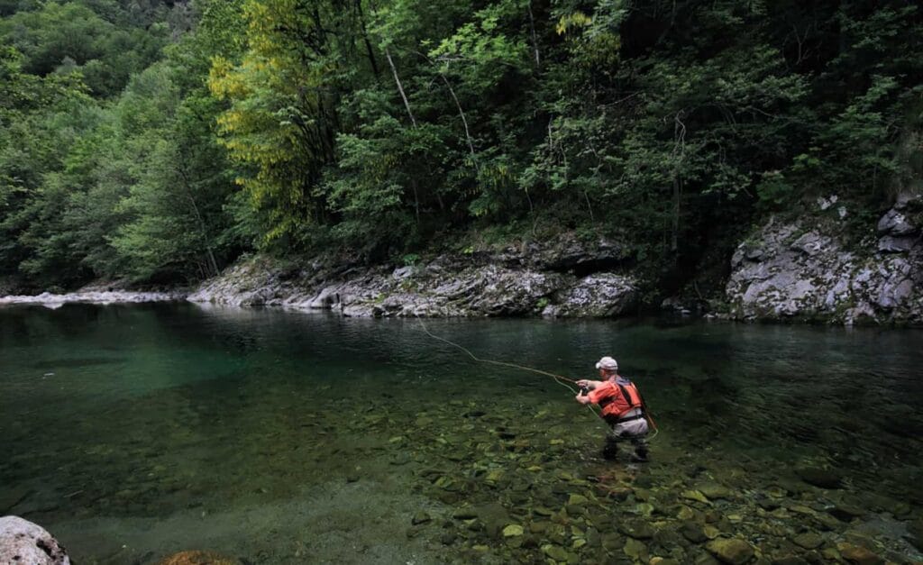 Fly fisherman casting in a mountain river in Montenegro